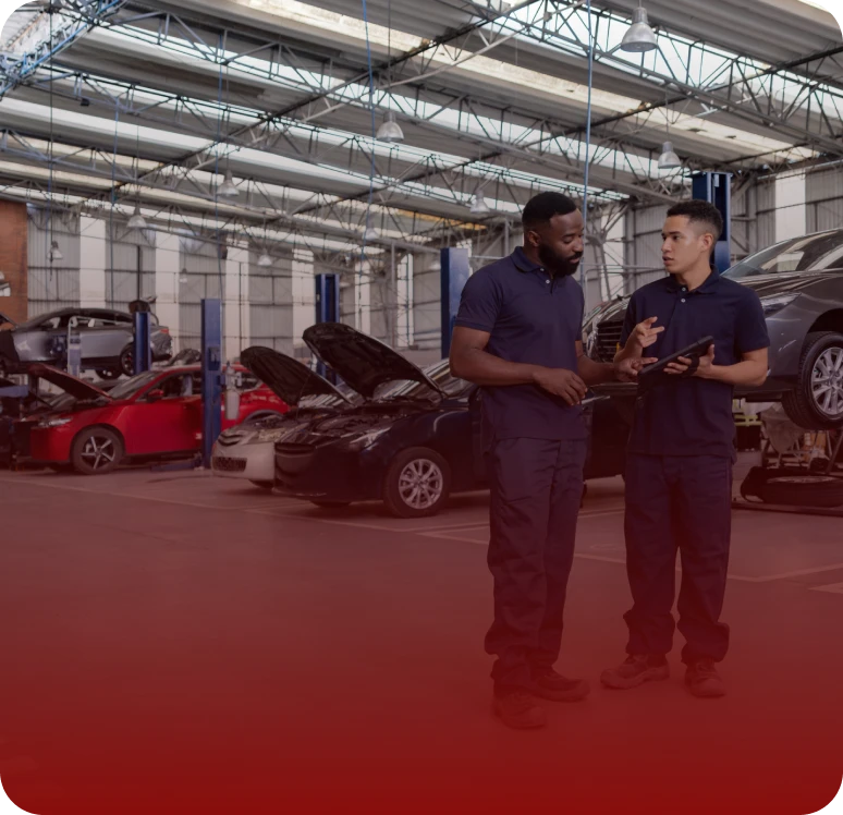 Auto repair workers in a garage setting.